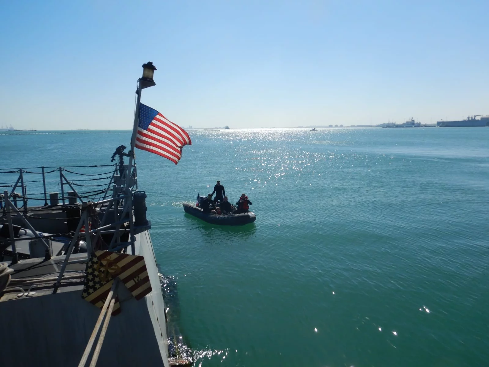 Un Zodiac s'aproche d'un bâtiment américain